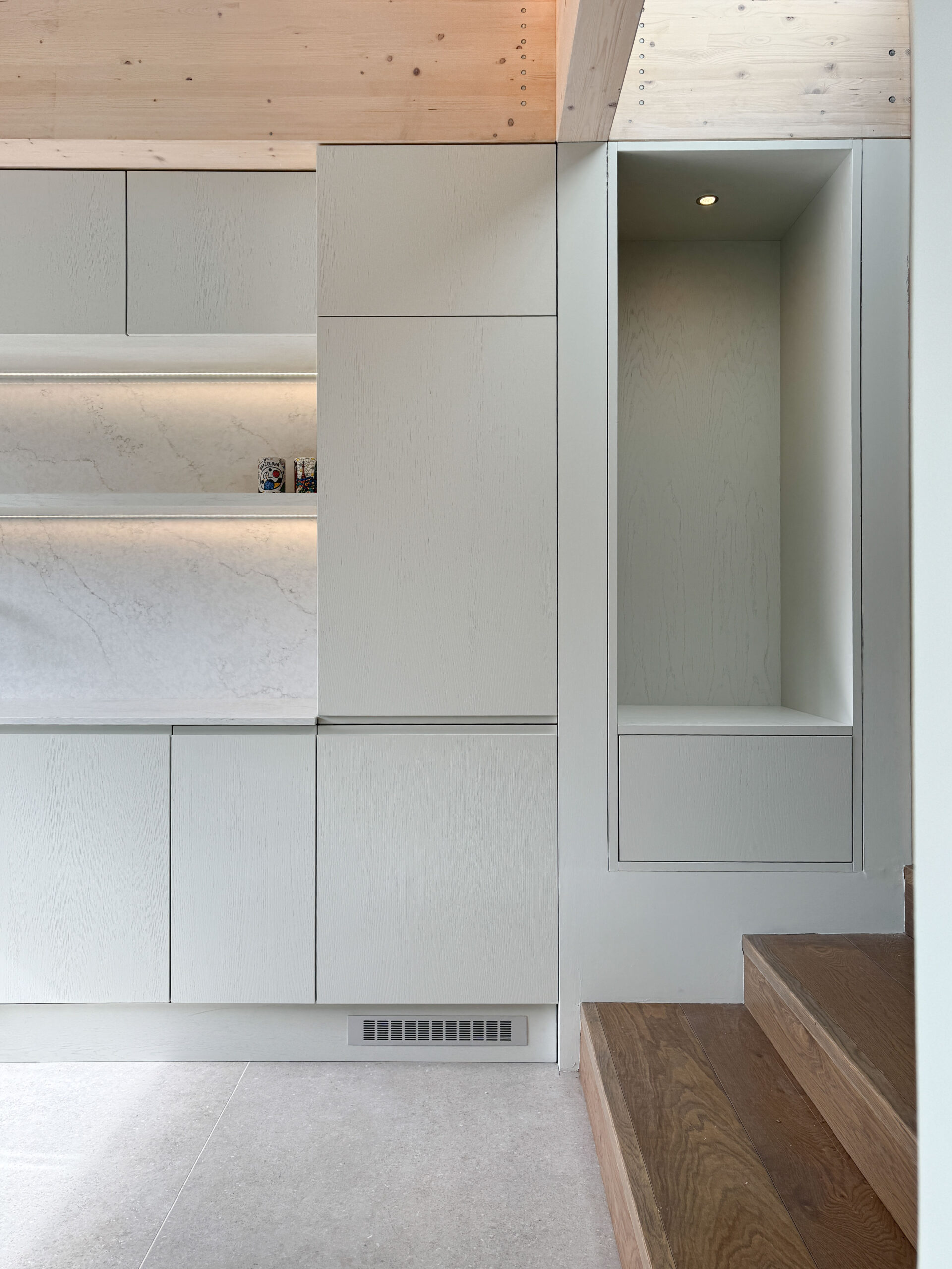 Custom made modern kitchen and utility space with large island, quartz worktop, hidden doors