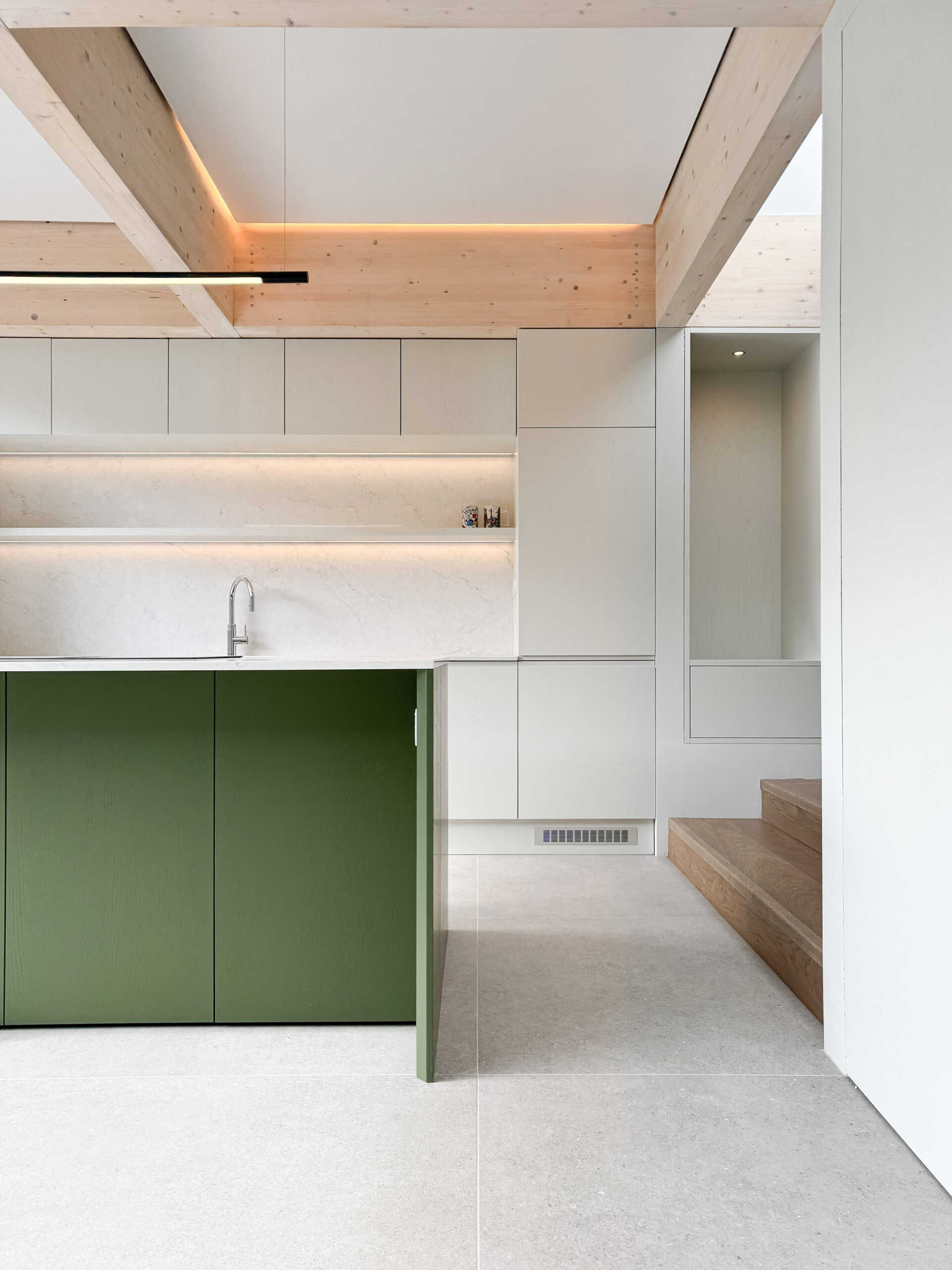 Custom made modern kitchen and utility space with large island, quartz worktop, hidden doors