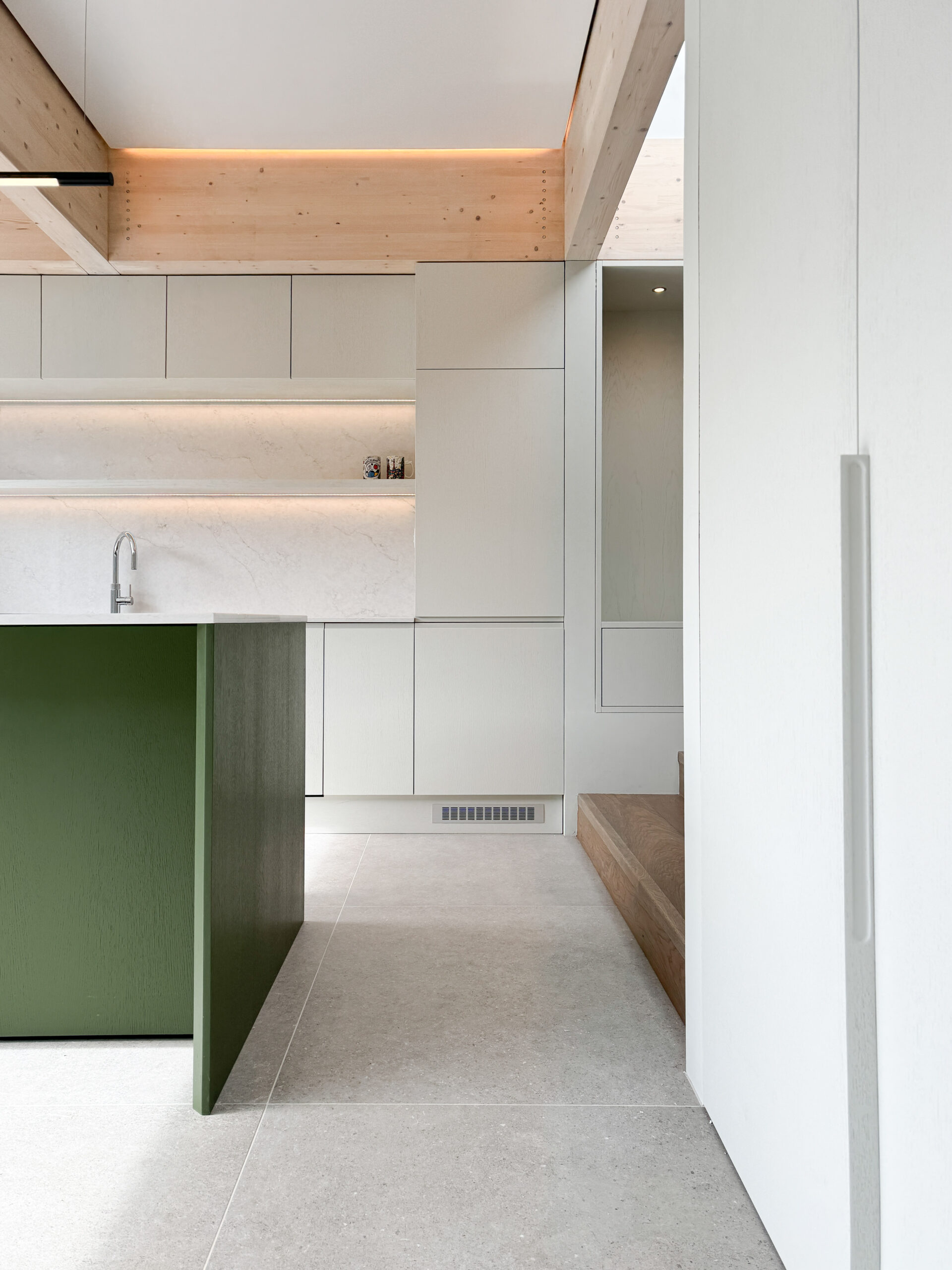 Custom made modern kitchen and utility space with large island, quartz worktop, hidden doors