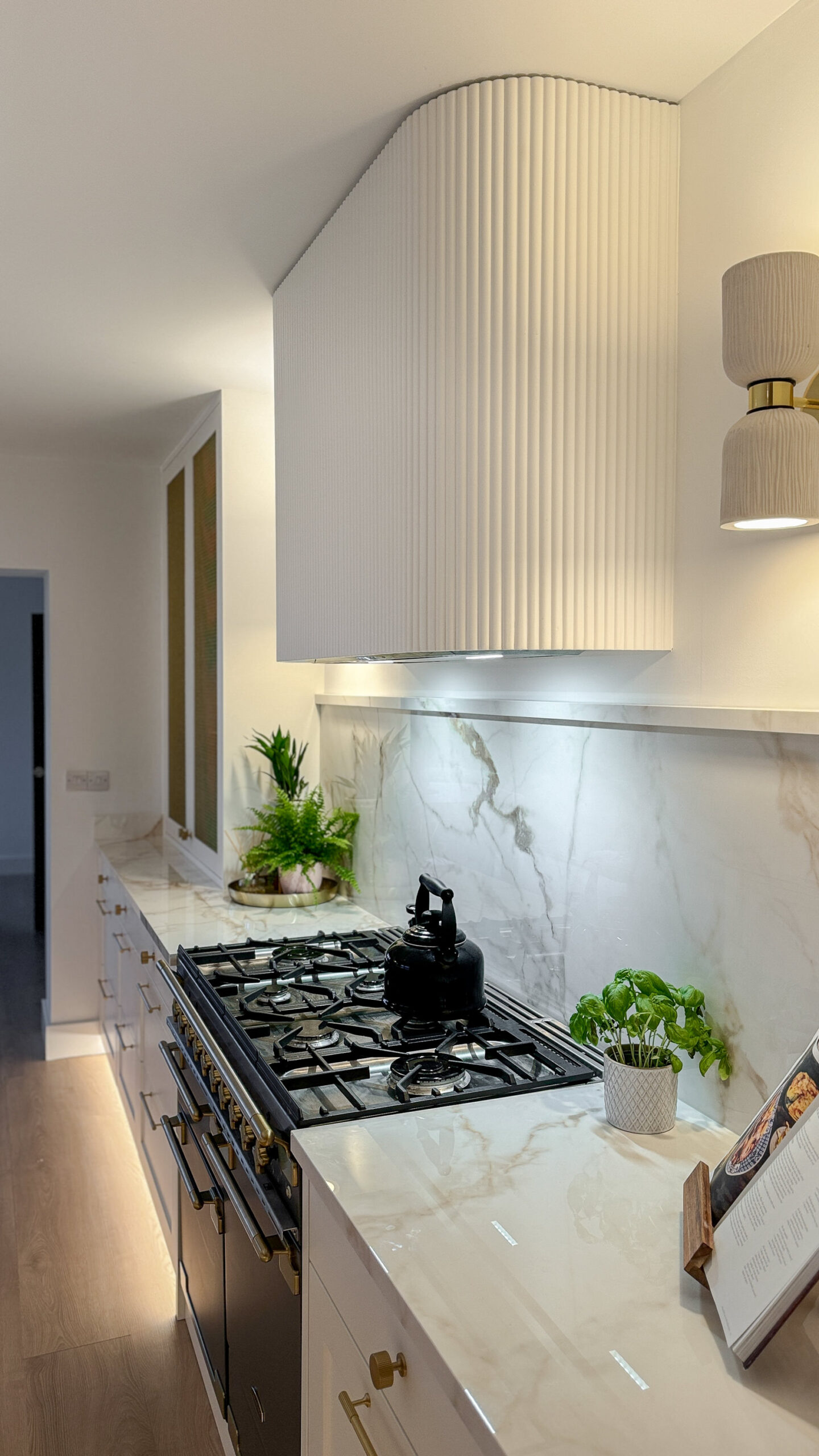 Custom made to measure modern classic kitchen with large island, quartz worktop, s-box power point, luxurious details and pendant lights