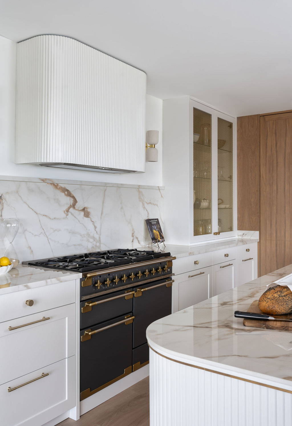 Custom made to measure modern classic kitchen with large island, quartz worktop, s-box power point, luxurious details and pendant lights