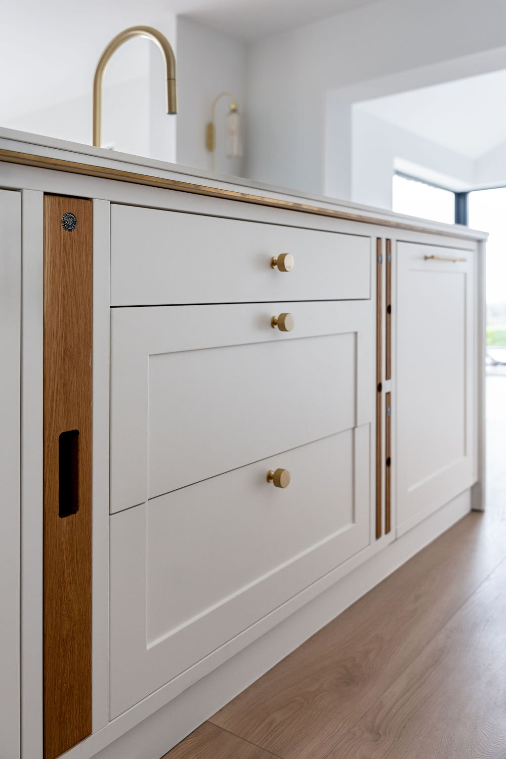 Custom made to measure modern classic kitchen with large island, quartz worktop, s-box power point, luxurious details and pendant lights