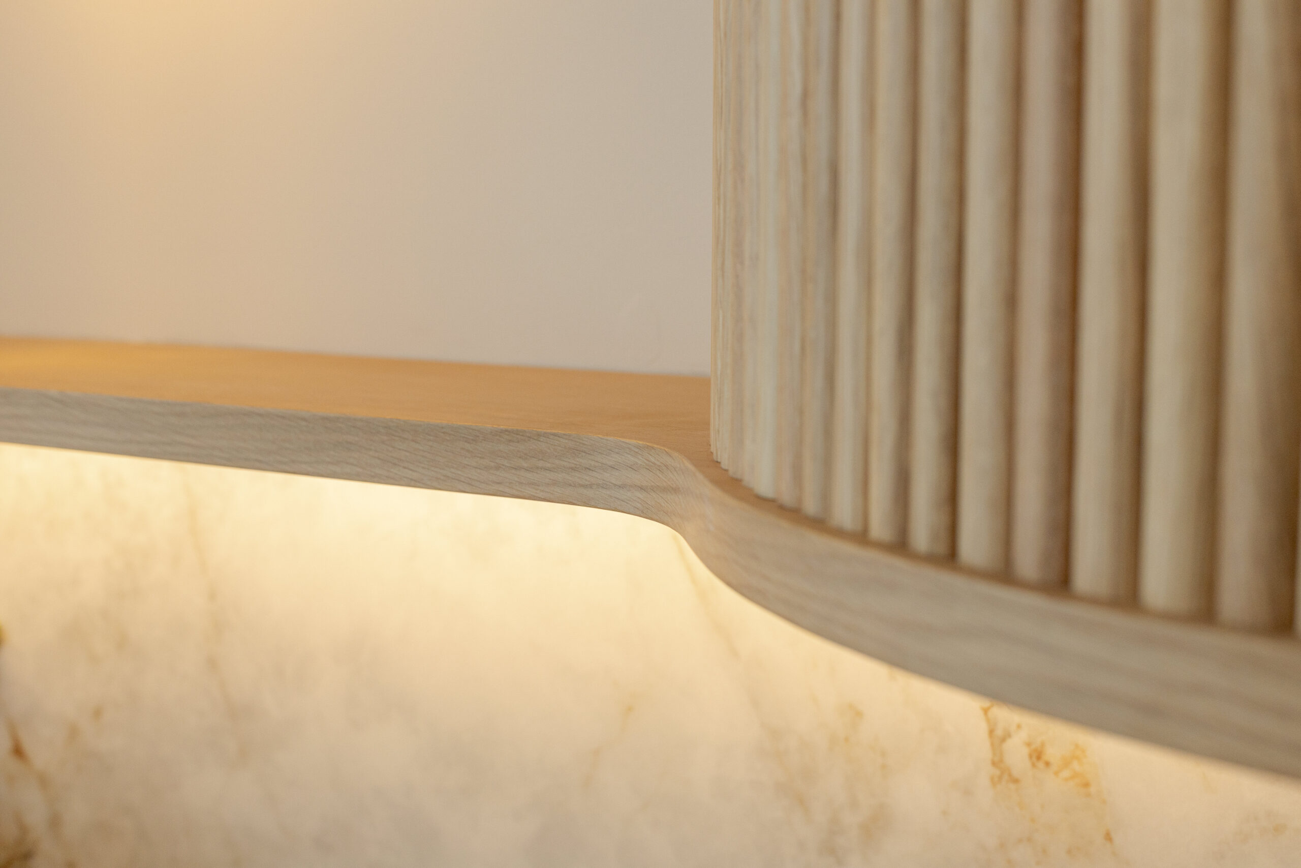 Custom made modern classical kitchen with large island, quartz worktop, and pendant lights and warm wood touch