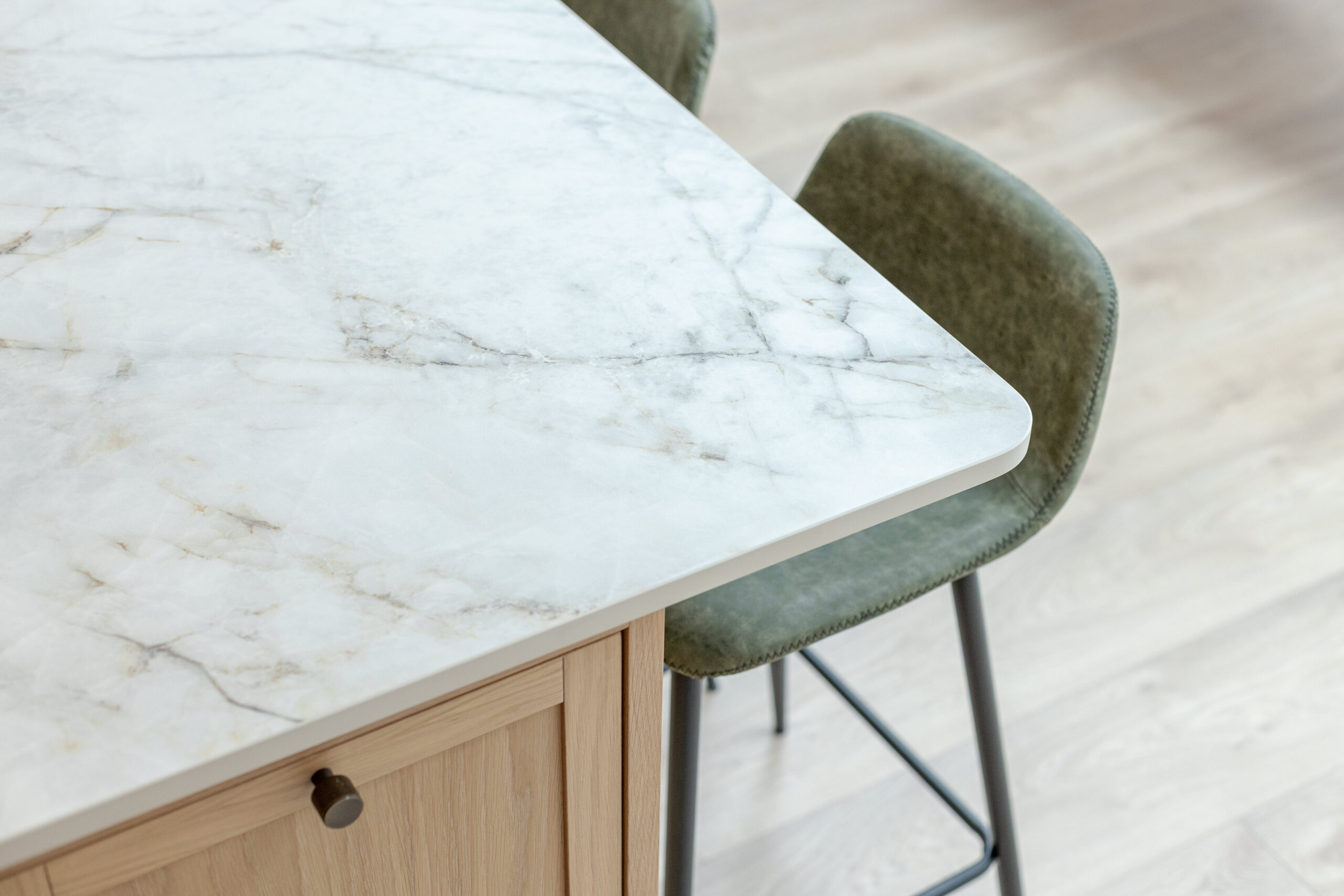 Custom made modern classical kitchen with large island, quartz worktop, and pendant lights and warm wood touch