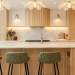 Custom made modern classical kitchen with large island, quartz worktop, and pendant lights and warm wood touch