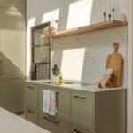 A refined modern classic kitchen combining timeless shaker cabinetry with contemporary finishes and natural warmth.